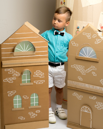 A little boy is playing with colorful houses.の写真素材