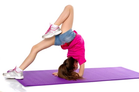 A gymnast performs an exercise stance on her forearms.の写真素材