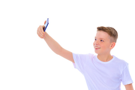 A cheerful little boy is making a selfie.