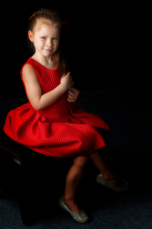 Little girl on a black backgroundの写真素材