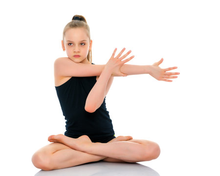 A little girl is meditating in a lotus pose.の写真素材