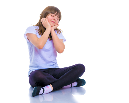 Little girl is sitting on the floor.の写真素材