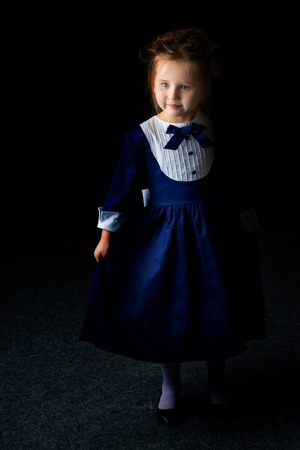 Little girl on a black backgroundの写真素材