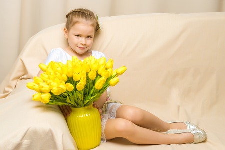 Little girl with a bouquet of flowersの写真素材