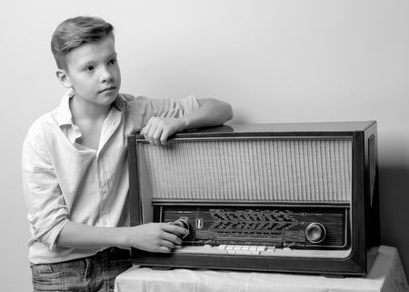 Boy teenager near old radio.の写真素材