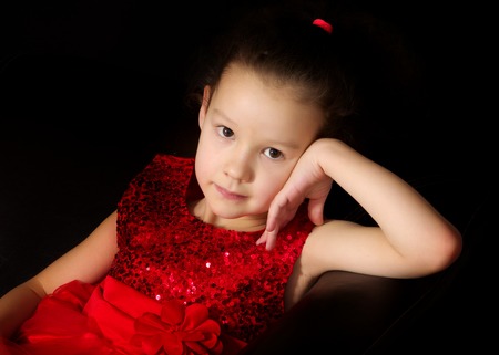 Little girl on a black backgroundの写真素材