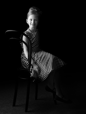 Little girl on a black backgroundの写真素材