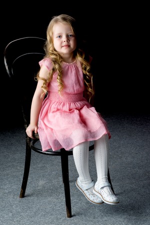 Little girl on a black backgroundの写真素材