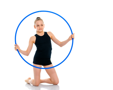 A girl gymnast performs an exercise with a hoop.の写真素材