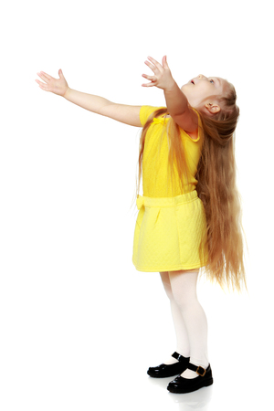A little blonde in a yellow t-shirt.の写真素材