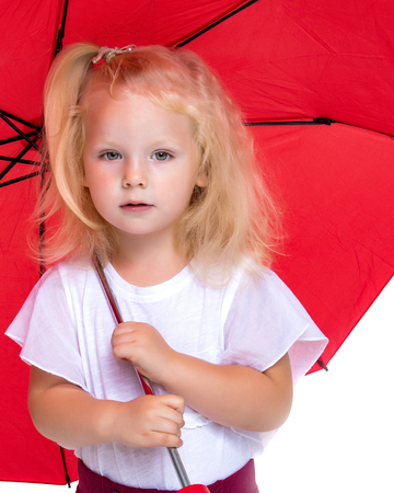 Little girl under an umbrella.の写真素材