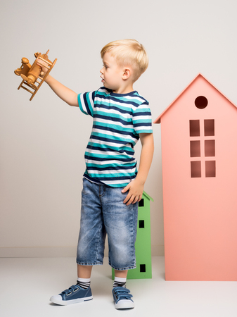 Little boy playing with wooden planeの写真素材