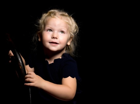 Little girl on a black backgroundの写真素材