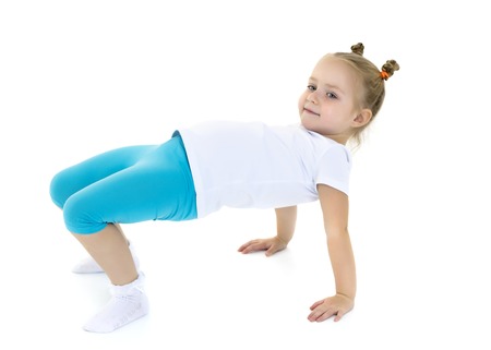 The little gymnast perform an acrobatic element on the floor.の写真素材