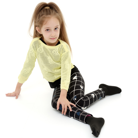 Little girl is sitting on the floor.の写真素材