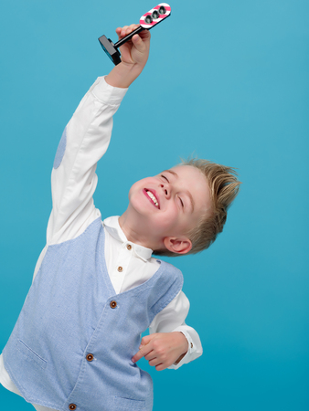 A little boy plays with a toy traffic light.の写真素材