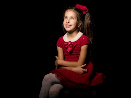 Little girl on a black backgroundの写真素材