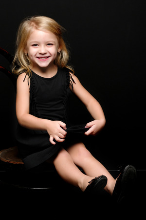 Little girl on a black backgroundの写真素材