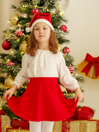 The girl at the Christmas tree.の写真素材