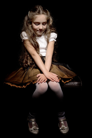 Little girl on a black backgroundの写真素材