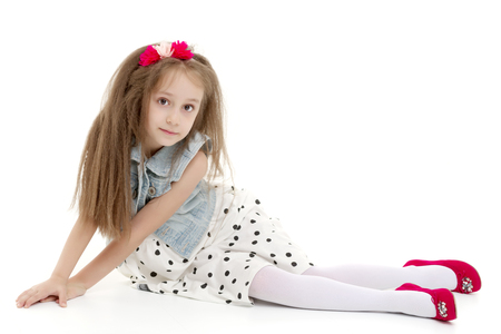Little girl is sitting on the floor.の写真素材