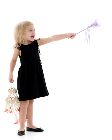A little girl with a magic wand.の写真素材
