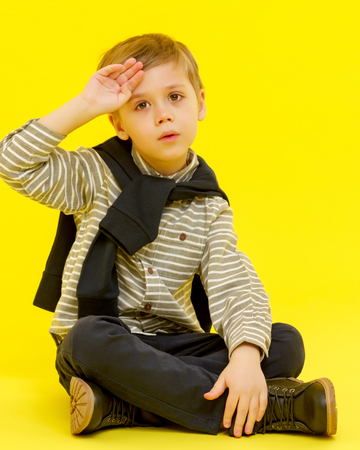 A little boy touches his forehead.の写真素材