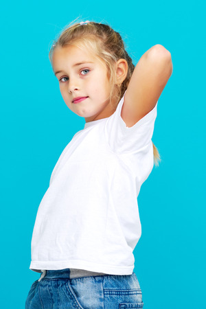 Emotional little girl in a clean white T-shirt.の写真素材