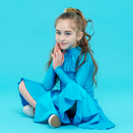Little girl is sitting on the floor.の写真素材