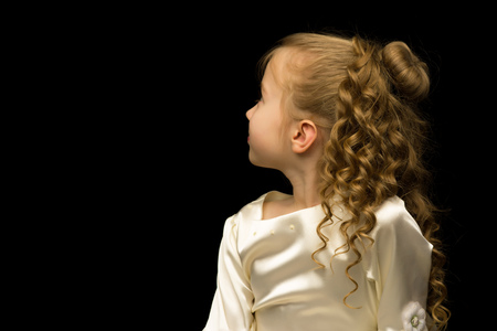 Little girl on a black backgroundの写真素材