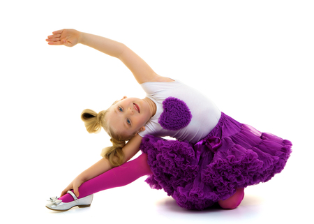 The little gymnast perform an acrobatic element on the floor.の写真素材