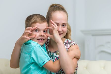Brother and sister, boy and girl posing in the studio. Friendshipの写真素材