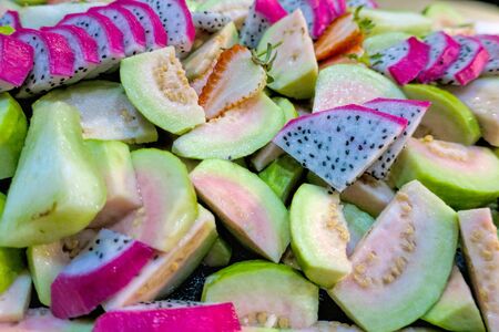 Fruit salad with cream in a bowl. Isolated on white background.の写真素材