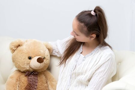 Little girl with teddy bearの写真素材