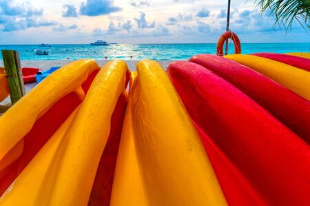 Boats for water activities in the Maldives lie on the shore