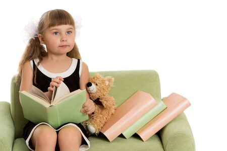 Little girl with a book.Isolated over white backgroundの写真素材