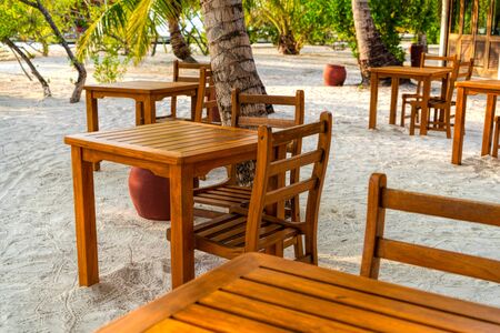 Wooden table and chairs by the tropical warm sea. Maldivesの写真素材