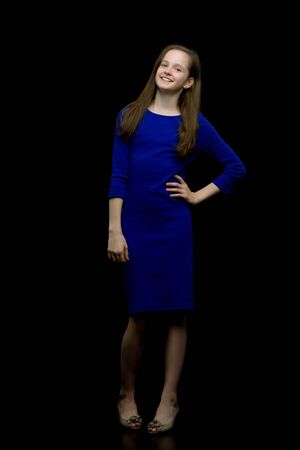 Fashionable girl teenager studio photo on a black background.の写真素材