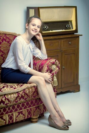 The girl is at the old radio.The concept of old things, Nostalgiの写真素材