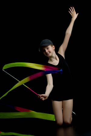 Girl gymnast performs exercises with tape.の写真素材