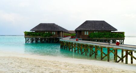 Wooden bridges leading to the huts on the shores of the tropicalの写真素材