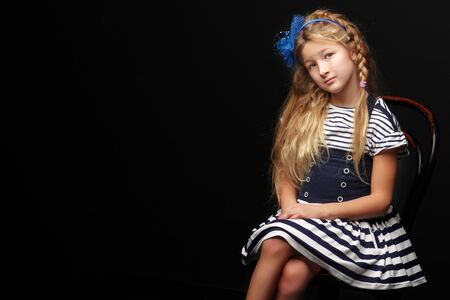 Little girl on a black backgroundの写真素材