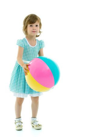 Little girl is playing with a ballの写真素材