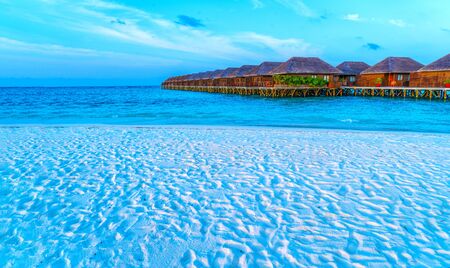 Wooden bridges leading to the huts on the shores of the tropicalの写真素材