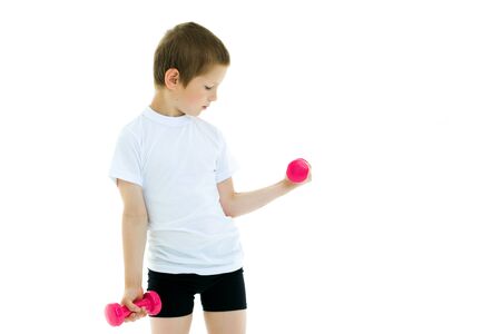 A little boy is lifting dumbbells.の写真素材