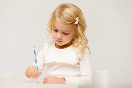 Little girl draws paints.montessori education.の写真素材
