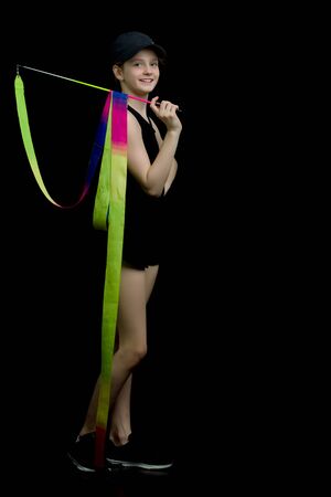 Girl gymnast performs exercises with tape.の写真素材