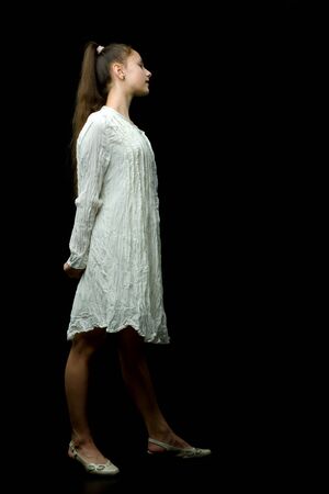 Beautiful young teen girl studio photo on black backgroundの写真素材