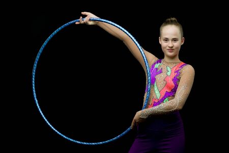A girl gymnast performs an exercise with a hoop.の写真素材