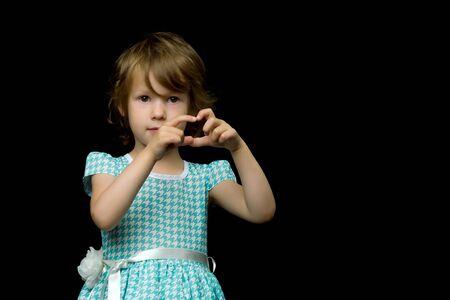 Little girl shows heart with her hands.の写真素材